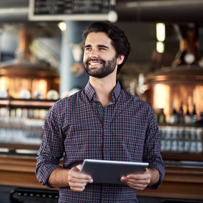 Man smiling with an iPad