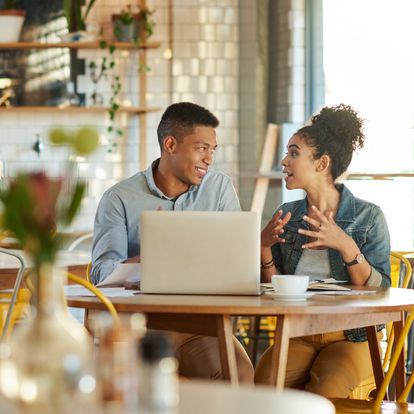 Man and woman sitting at a table talking