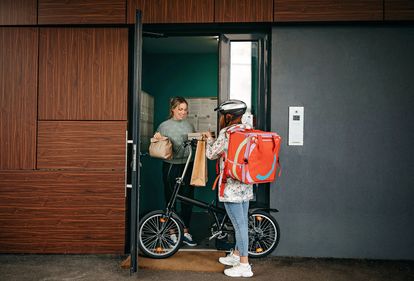 Photo of courier with bike.