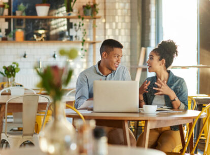 Two friends having a conversation at a restaurant