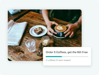 An image of a coffee along with other baked goods on a coffee shop table.